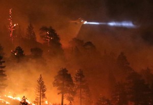 Los Angeles county fire helicopter makes a water drop to battle wild land fire call the Pine Fire in Wrightwood, California