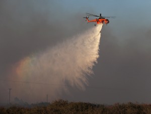 A sky crane helicopter makes a water drop at the North Fire near Phelan
