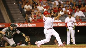 Los Angeles Angels' Albert Pujols hits a slow chopper in front of home plate while batting with the bases loaded against the Oakland Athletics in the eighth inning of baseball game Monday, Sept. 26, 2016, in Anaheim, Calif. Pujols was thrown out at first but a runner scored from third for what turned out to be the winning run. (AP Photo/Lenny Ignelzi)