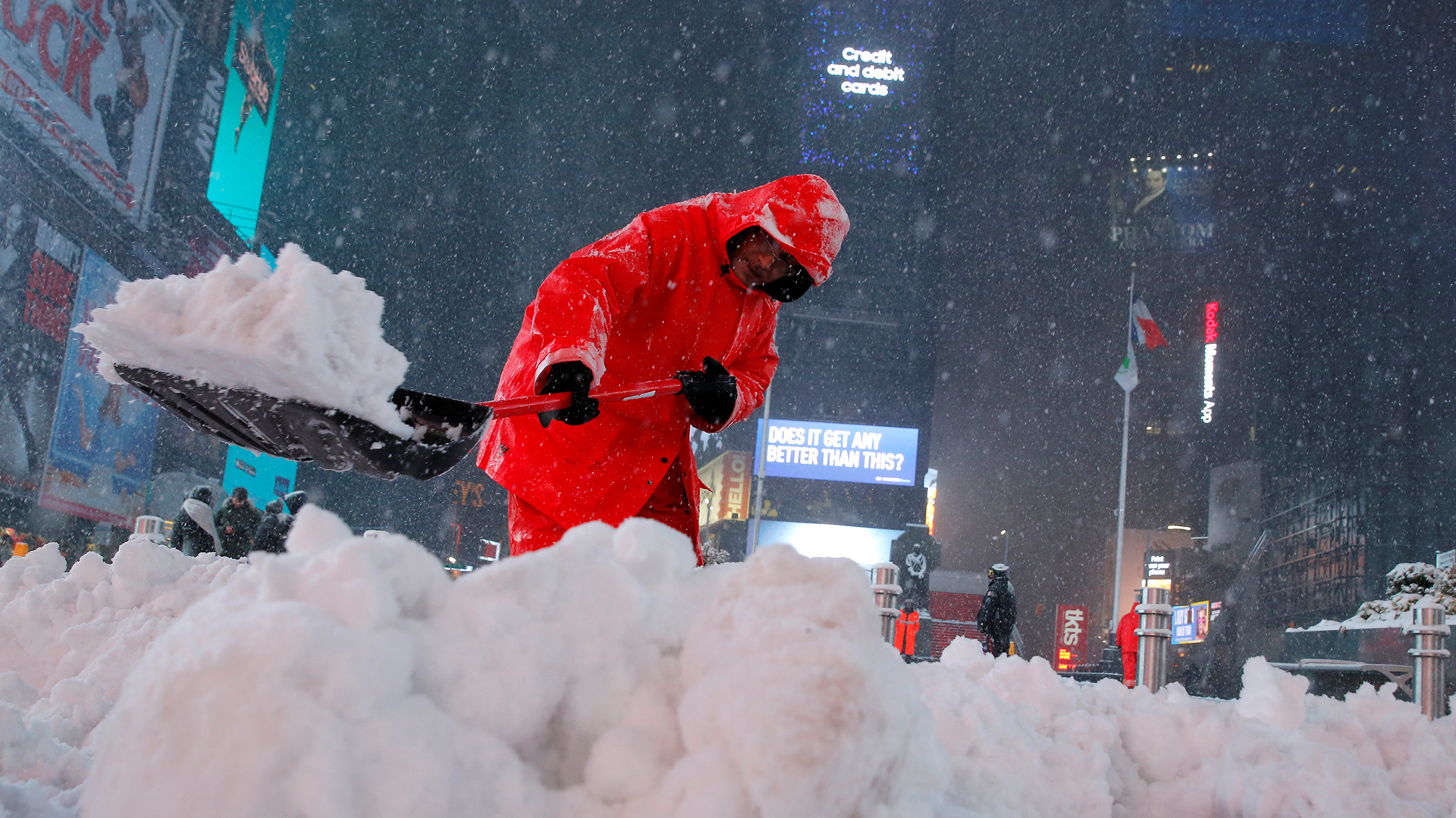A worker clears snow in Times Square as snow falls in Manhattan, New York, U.S., March 14, 2017. REUTERS/Andrew Kelly