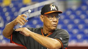 Miami Marlins' special assistant to the president, Tony Perez, left, speaks with Miami Marlins shortstop Adeiny Hechavarria before the team met the Milwaukee Brewers in their baseball game in Miami, Saturday, May 24, 2014. (AP Photo/Joe Skipper)