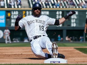 DENVER, CO - SEPTEMBER 20:  Charlie Blackmon #19 of the Colorado Rockies slides safely into third base with a triple in the third inning of a game against the Arizona Diamondbacks at Coors Field on September 20, 2014 in Denver, Colorado.  (Photo by Dustin Bradford/Getty Images)