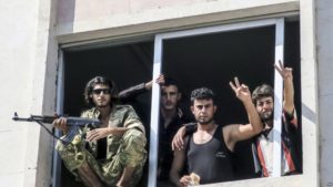 Free Syrian Army fighters gesture in Jarablus, Syria, Wednesday, Aug. 31, 2016. Turkish military officials say Turkish jets have struck four buildings in Syria’s Islamic State group-held Zaghrah and Kuliyeh regions, destroying the edifices as well as “terrorists” inside. The officials also said Wednesday that Turkish artillery had fired 107 rounds at 25 “terrorist” targets in the villages of Zavgar and Kuliyeh since Tuesday. The villages are situated west of the key border town of Jarablus which was retaken by Turkey-backed Syrian rebels.)AP Photo)
