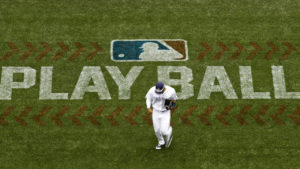 San Diego Padres left fielder Allen Cordoba passes a logo for Play Ball, an initiative from Major League Baseball and USA Baseball, during the fifth inning of a baseball game against the Colorado Rockies Saturday, June 3, 2017, in San Diego. (AP Photo/Gregory Bull)