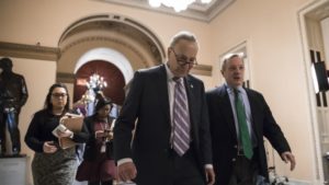 Senate Minority Leader Chuck Schumer, D-N.Y., left, walks with Sen. Dick Durbin, D-Ill., the minority whip, as lawmakers continue negotiating on a deal that would include a fix for the Deferred Action for Childhood Arrivals (DACA) program, at the  Capitol in Washington, Thursday, Jan. 11, 2018.  (AP Photo/J. Scott Applewhite)