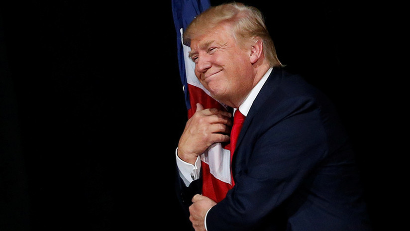 ¿Agresión o afecto?: La extraña manera de Trump de abrazar la bandera, causa polémica en la Red