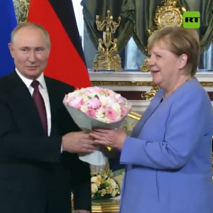 Putin recibe a Merkel en el Kremlin con un ramo de flores